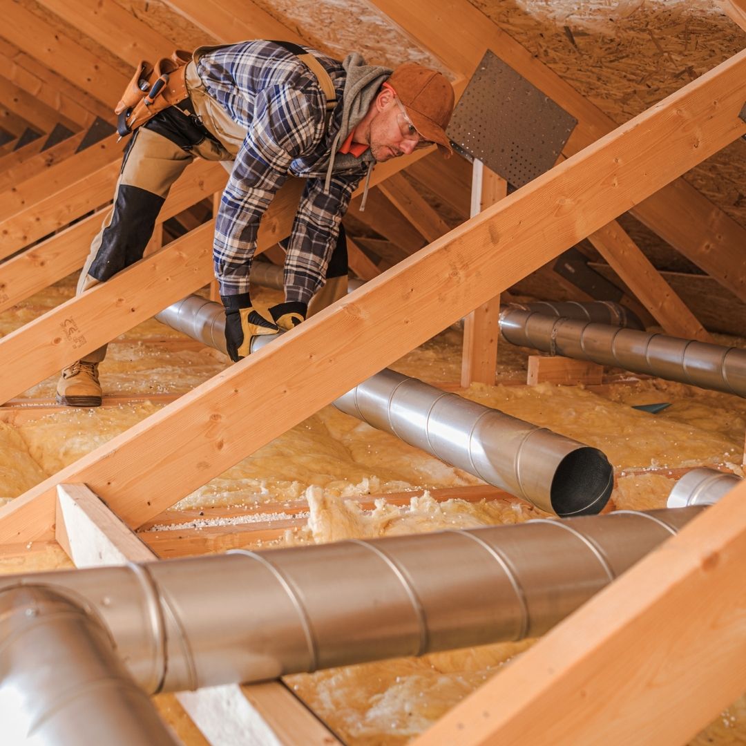 Image of a person installing insulation.