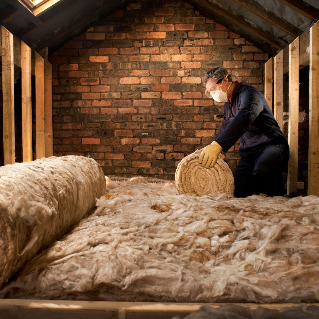 image of a person installing insulation.